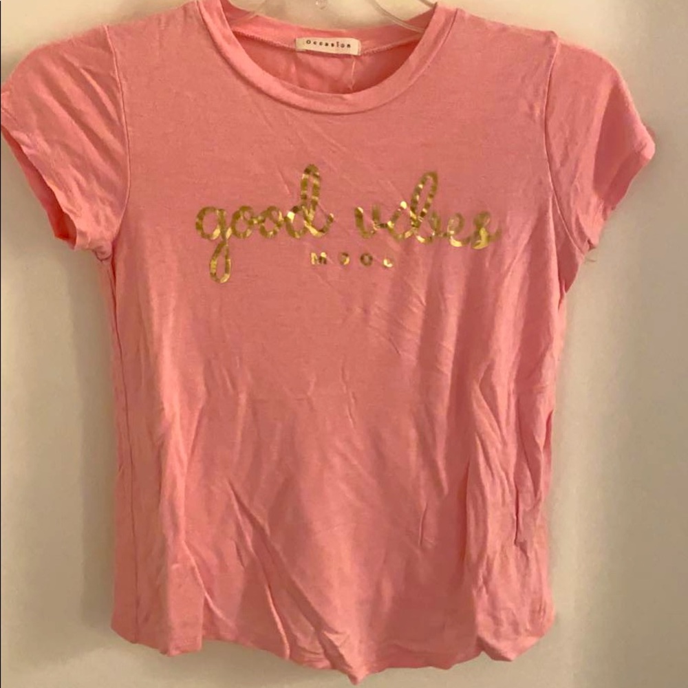 Light but bright pink shirt with gold lettering!